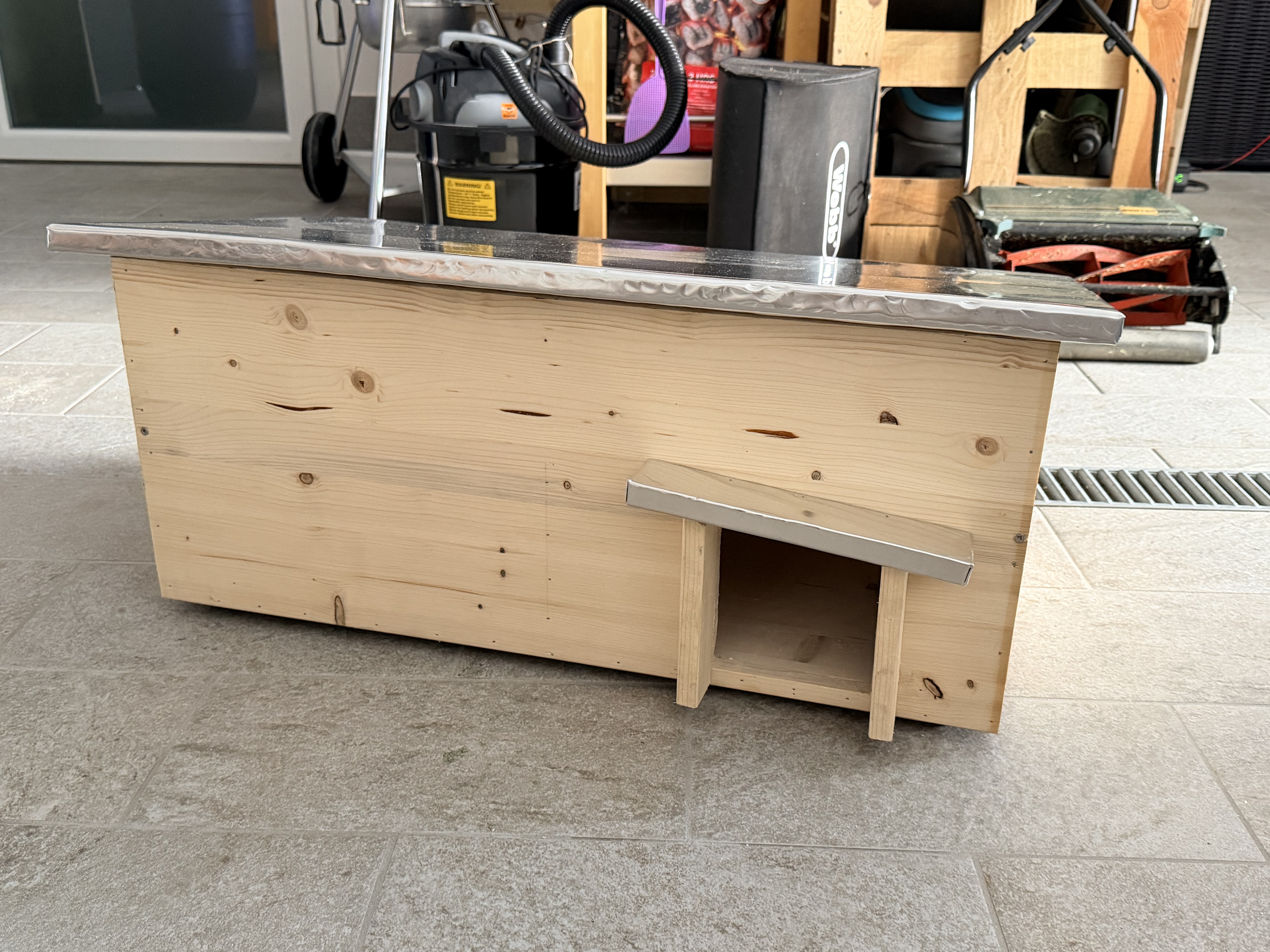 130 mm square entrance hole cut into the front panel of the wooden hedgehog house