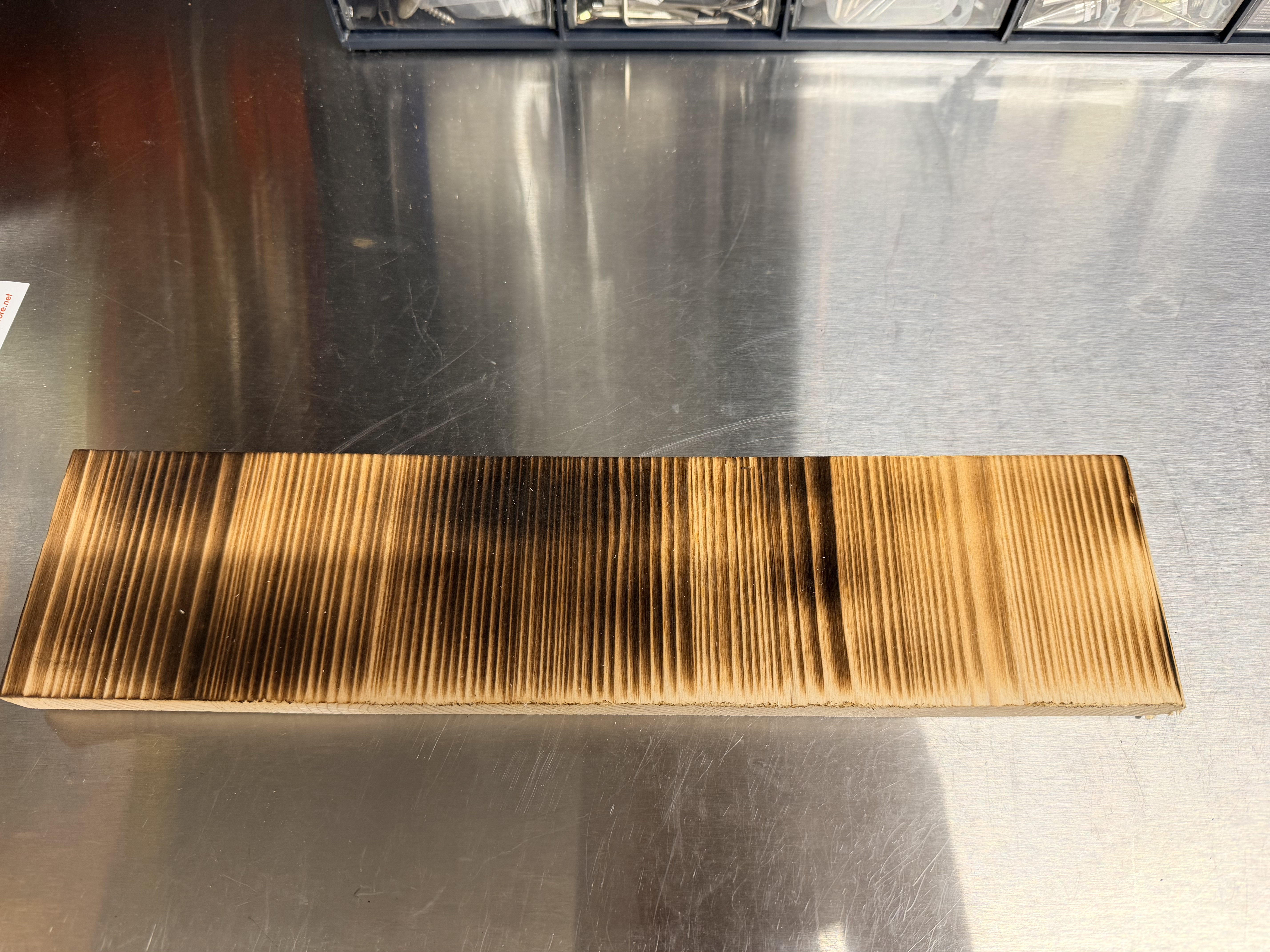 Test piece of pine with an uneven flame-charred surface